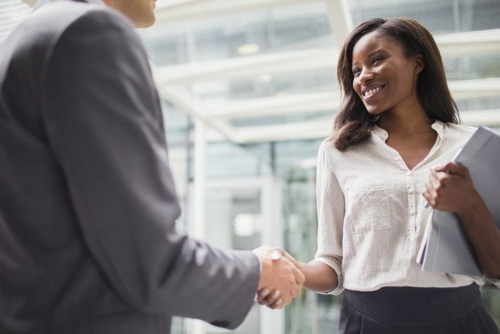 A woman shakes an interviewer's hand