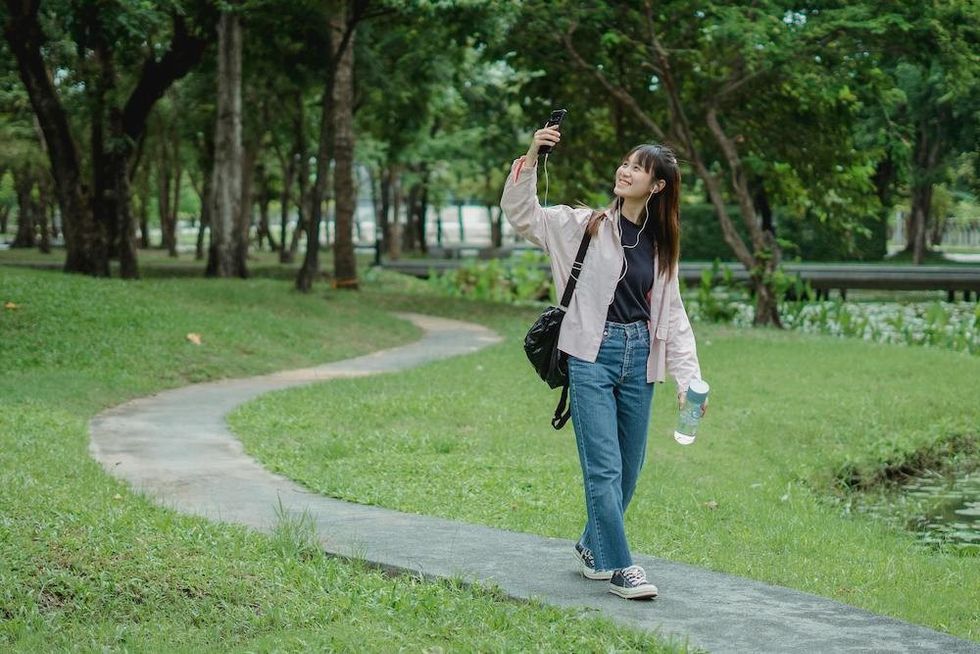 a woman talking on the phone while taking a walk