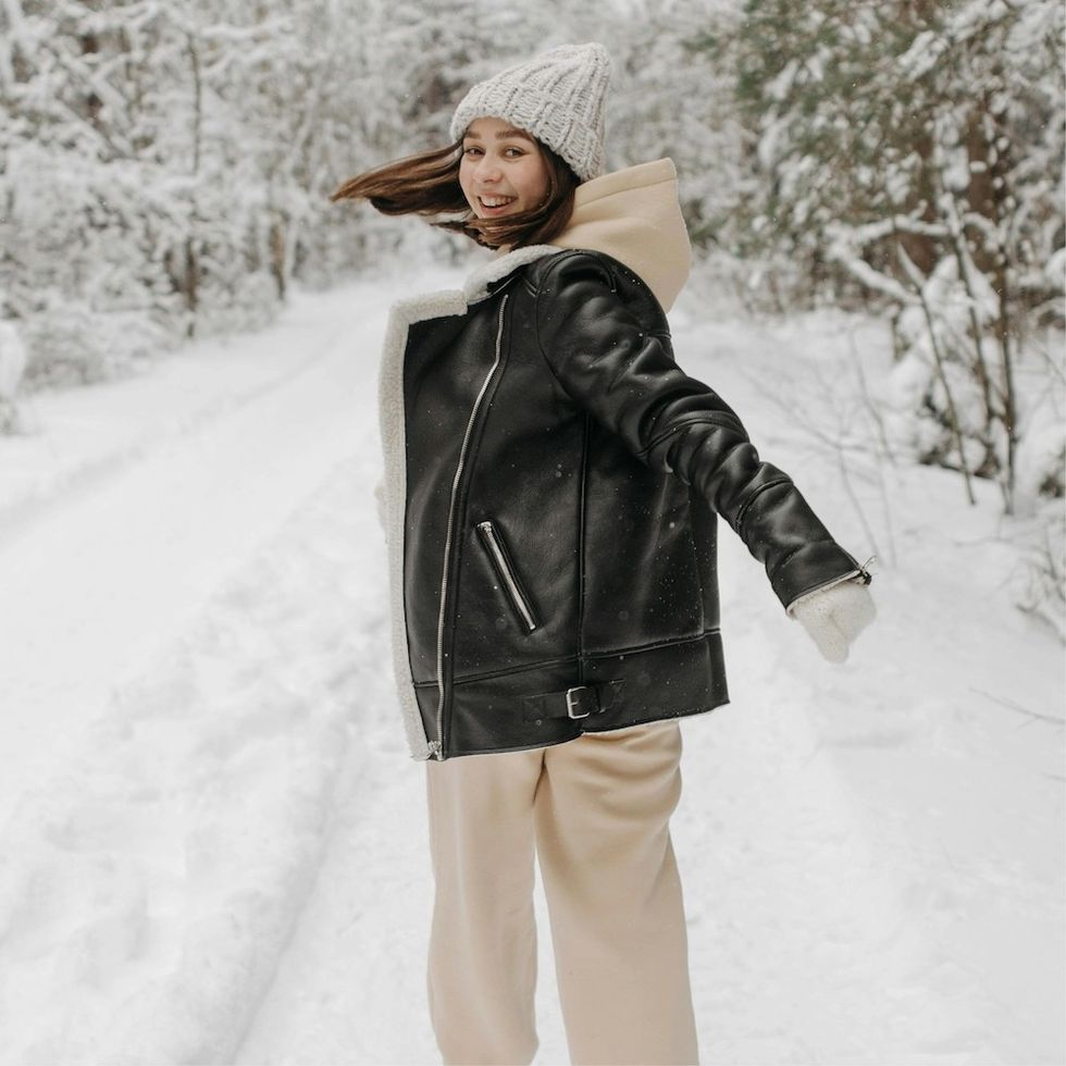 a woman walking in the winter snow