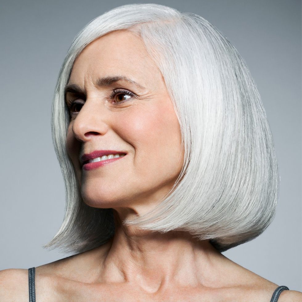 a woman with a curled under gray bob