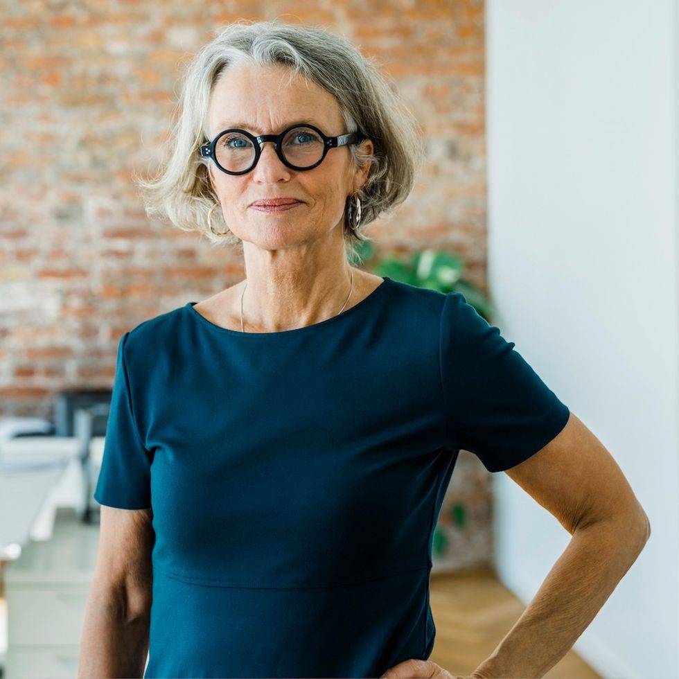 a woman with a curled under gray bob