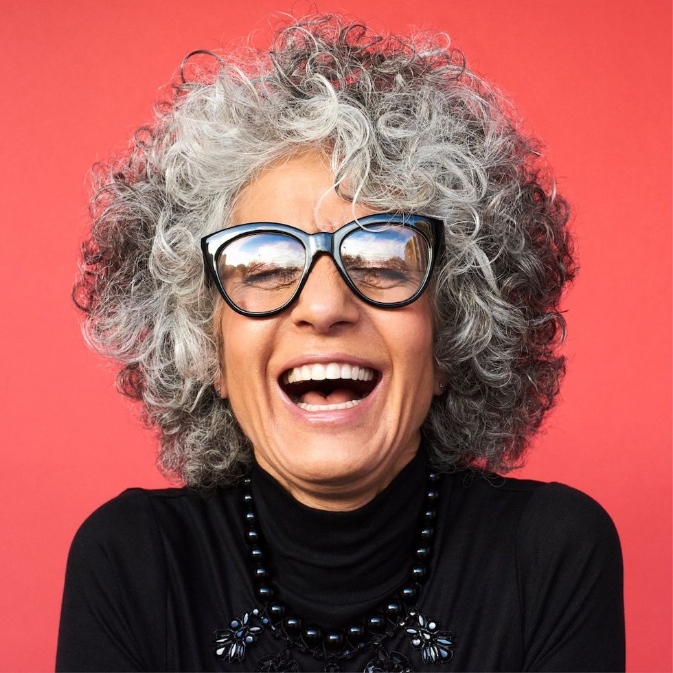 a woman with a curly gray bob hairstyle