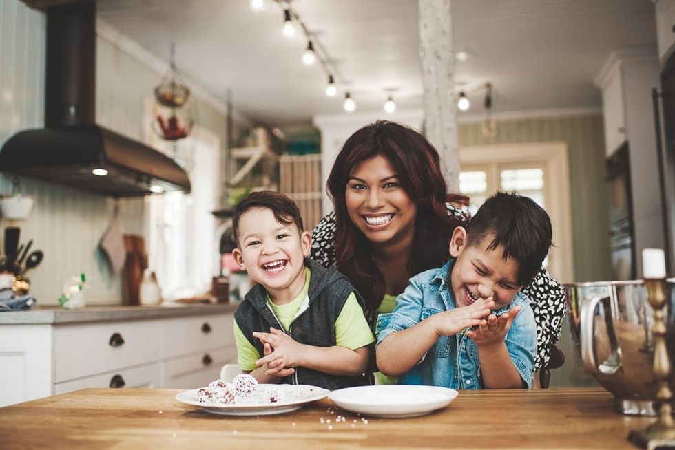 A women and her children bake together