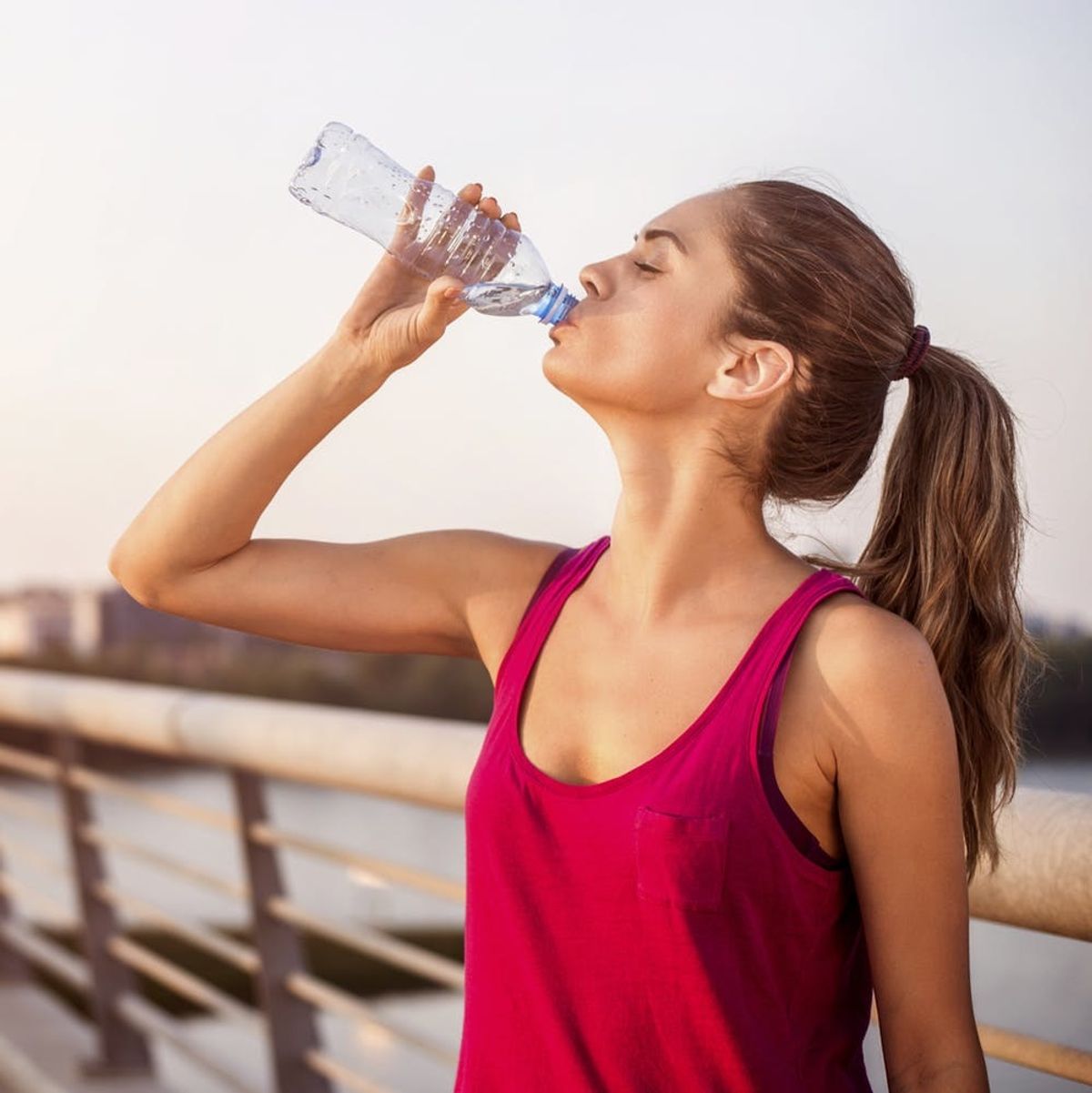 Active woman enjoying bottled water