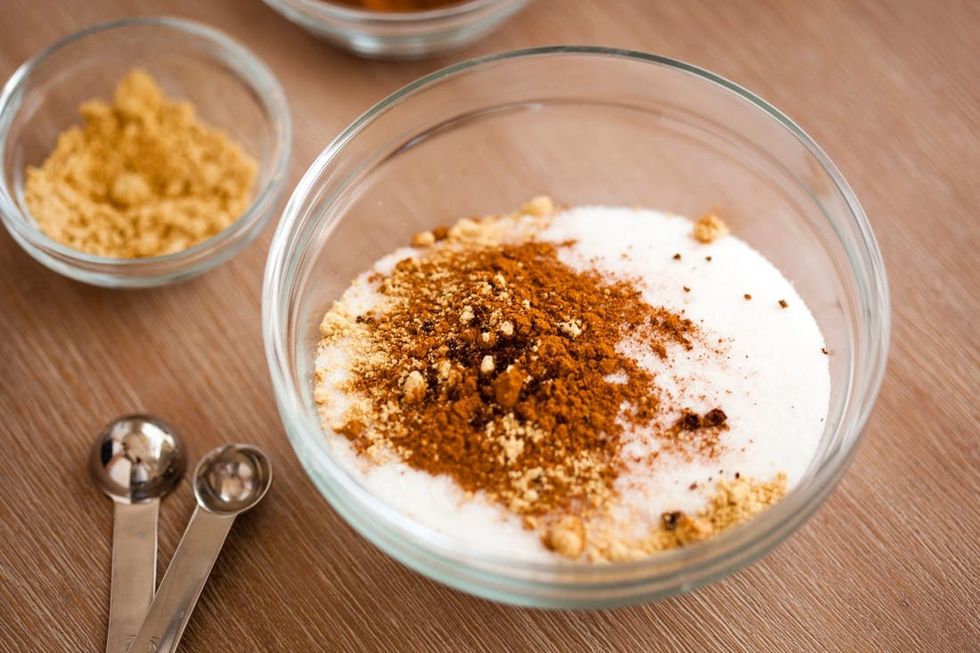 adding sugar, cinnamon, ginger, cloves and salt to our pumpkin pie recipe