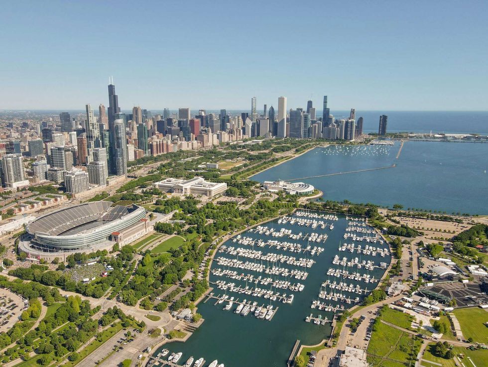 Aerial view of Chicago skyline, stadium, and marina by Lake Michigan on a clear day.