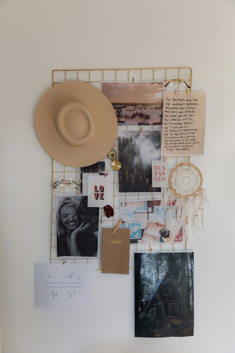 Aesthetic wall collage with a hat, photos, a dreamcatcher, notes, and a small notebook.