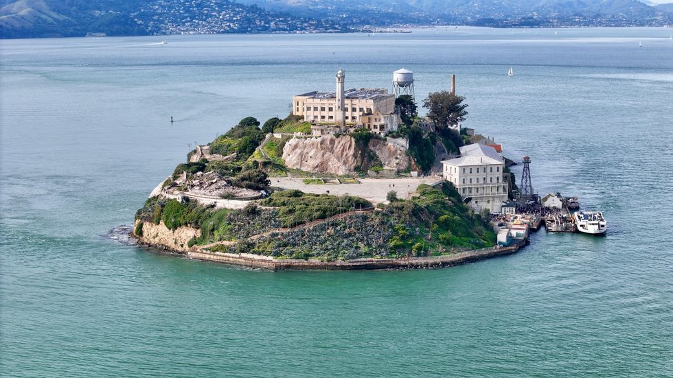 Alcatraz Island with historic prison buildings surrounded by water.