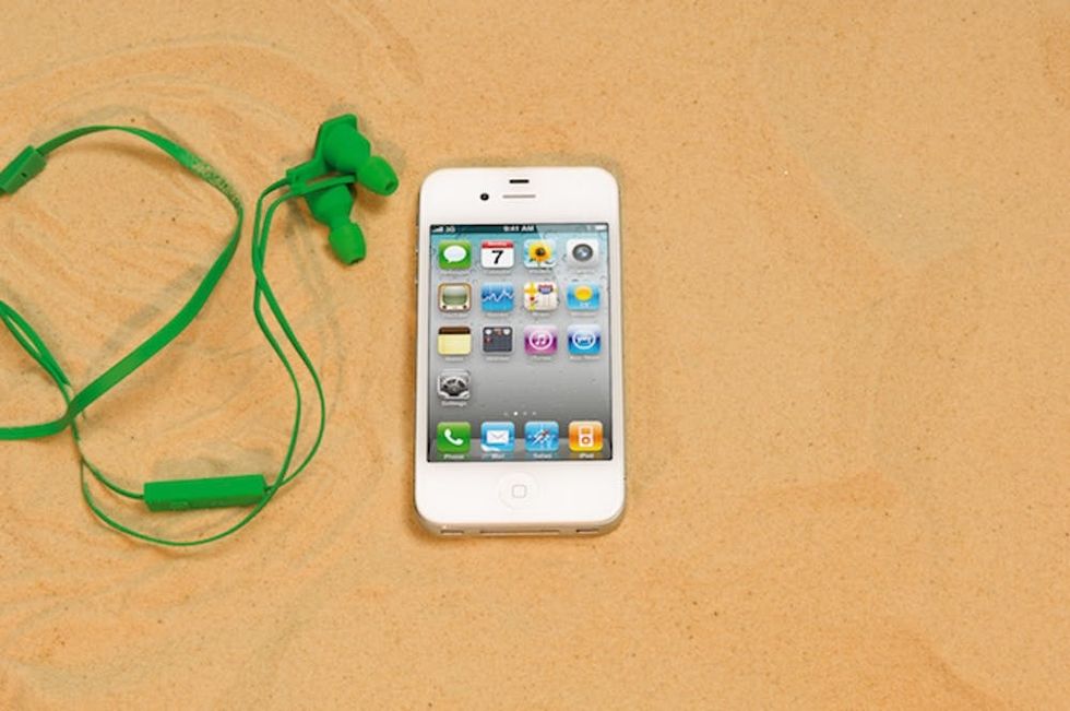 An Apple iPhone 4, shot in a beach scenario during a holiday technology feature, February 6, 2012. (Photo by What Laptop magazine/Future Publishing via Getty Images)