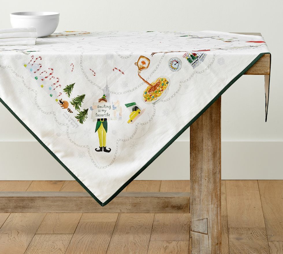 An Elf table throw is lying on top of a table.