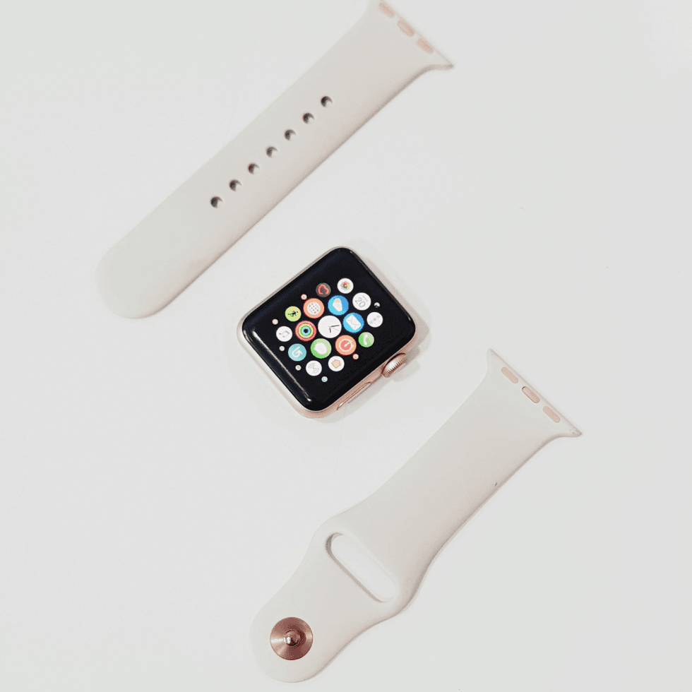 Apple Watch and watch band sitting on a white surface