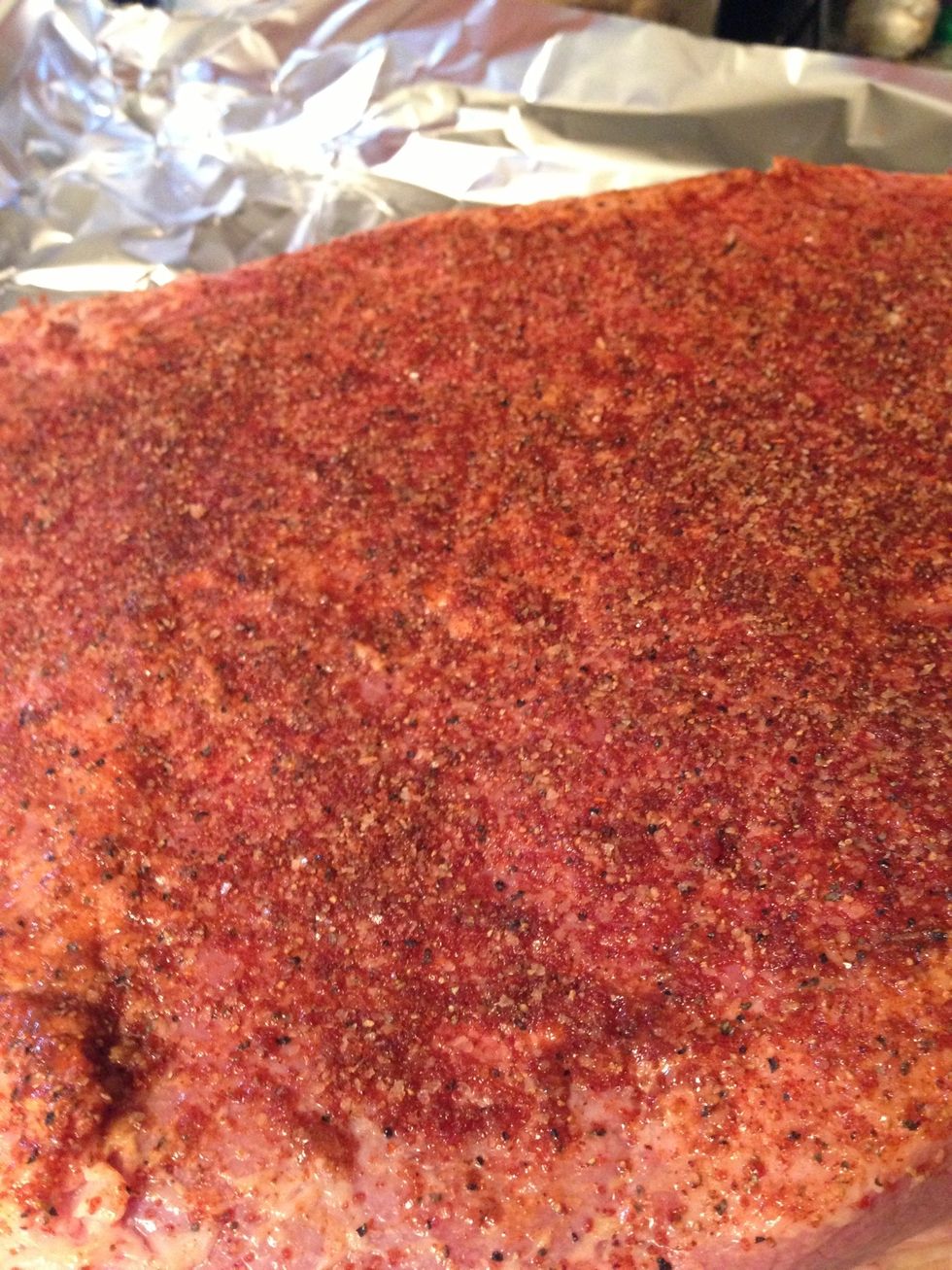 Apply the mustard and cover the brisket with a thin layer. Then liberally apply the dry rub, making sure to get it in all of the channels you made by scoring the fat cap.