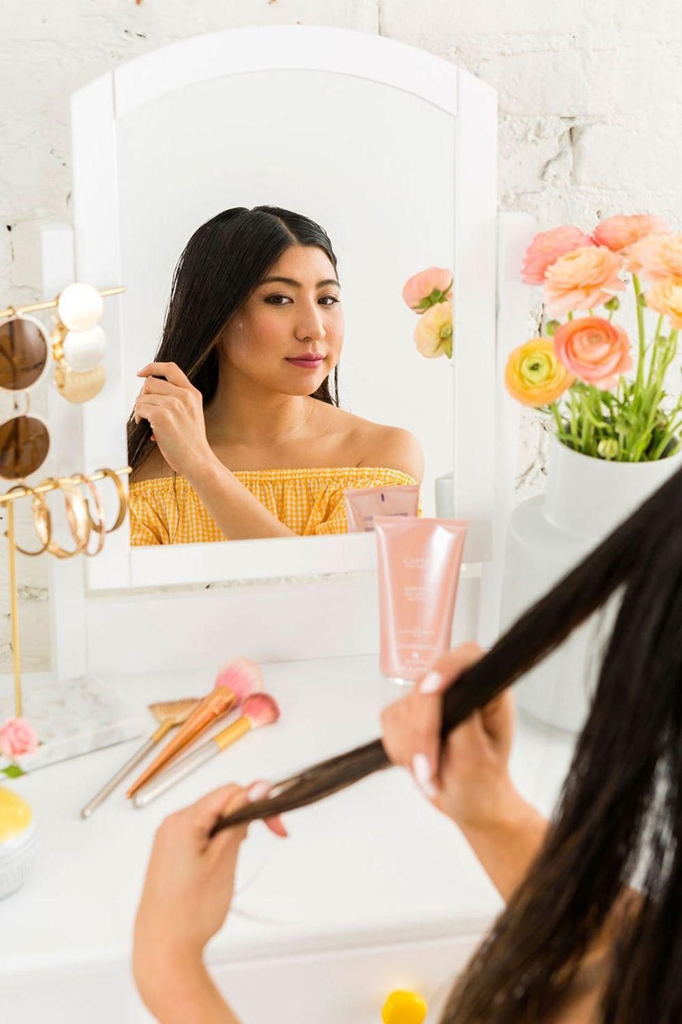 applying blowout butter to hair