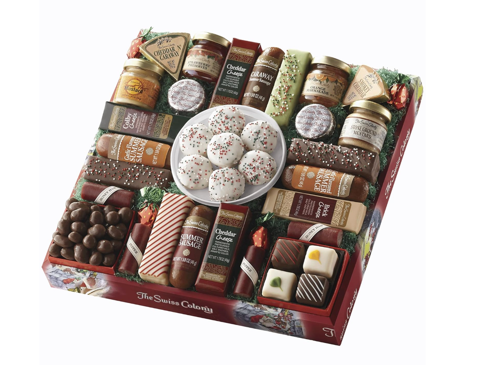 Assorted food gift box with cheeses, sausages, mustard, and festive cookies.