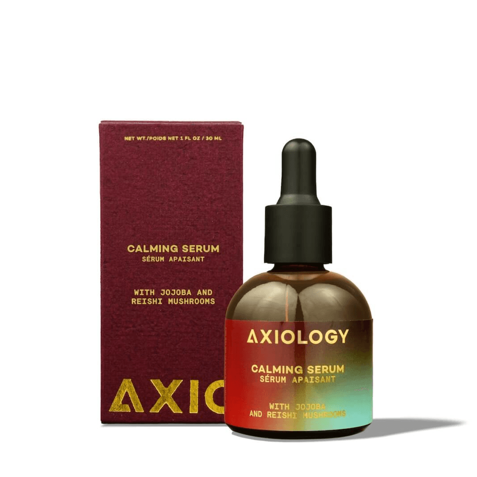 Axiology Calming Serum with Jojoba and Reishi, next to its maroon box.
