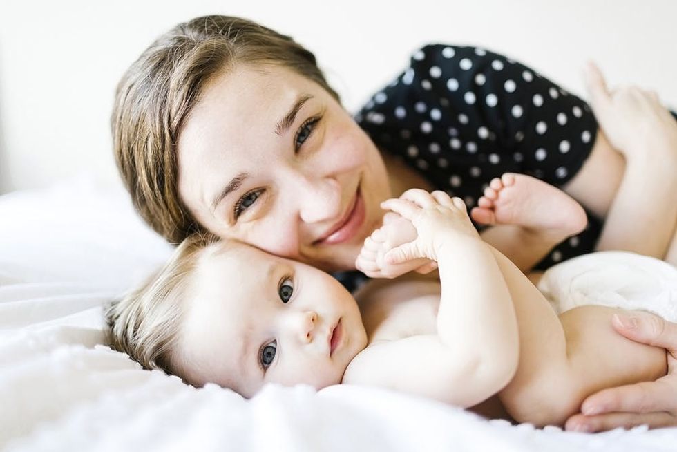 Baby and mom smiling at camera