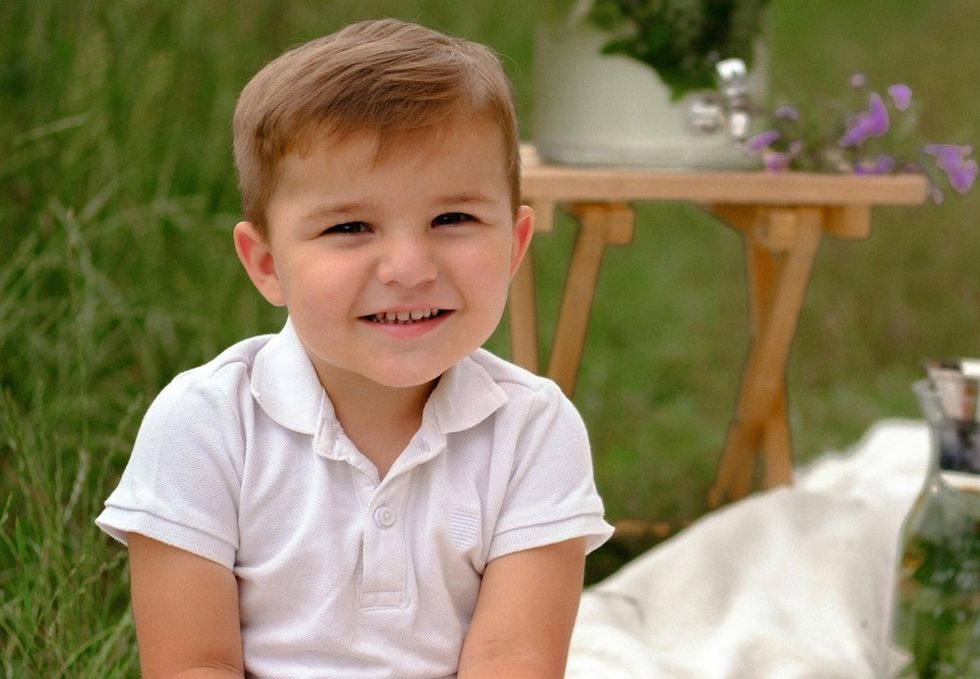 baby boy sitting in a field