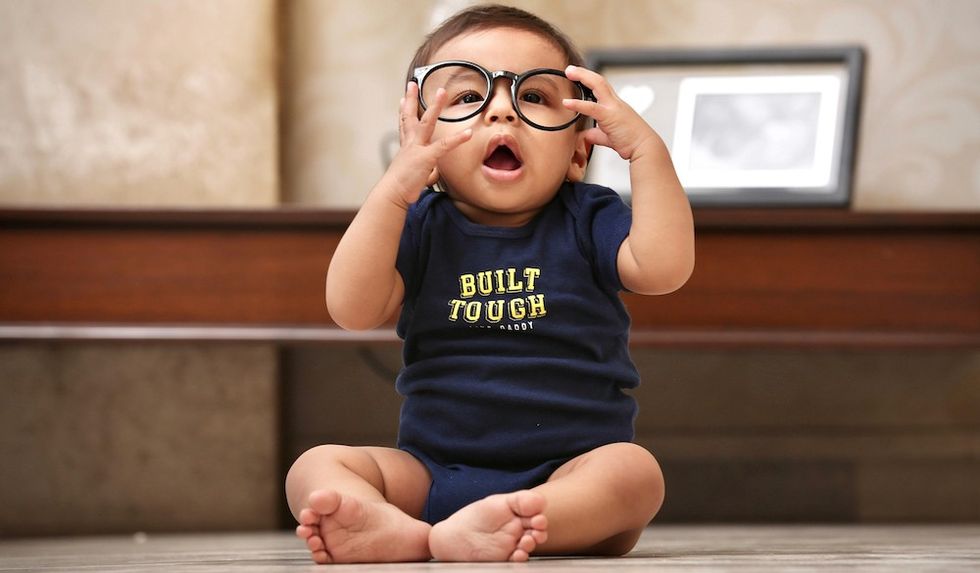 baby boy with a "built tough" onesie on