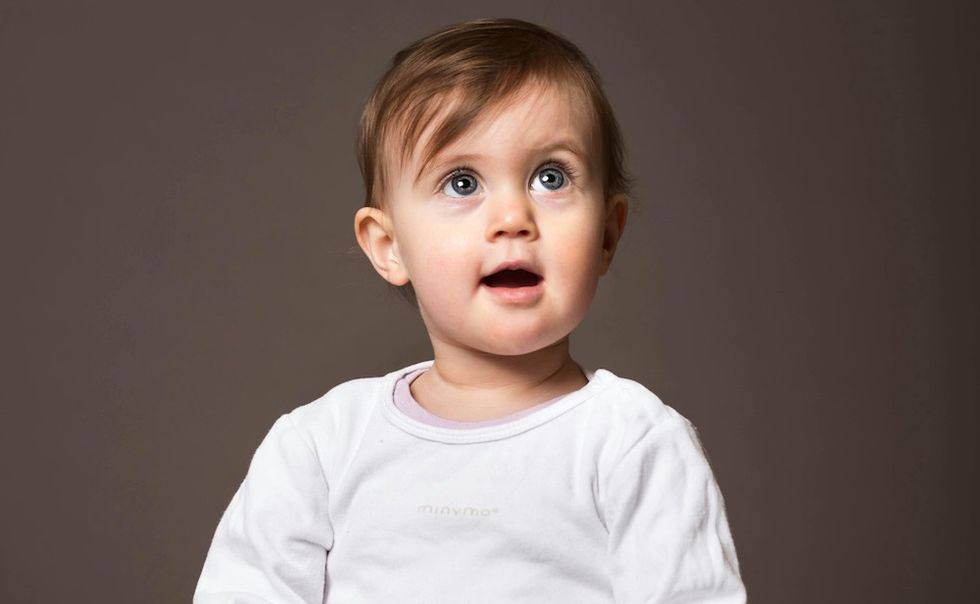 baby girl in front of a gray background
