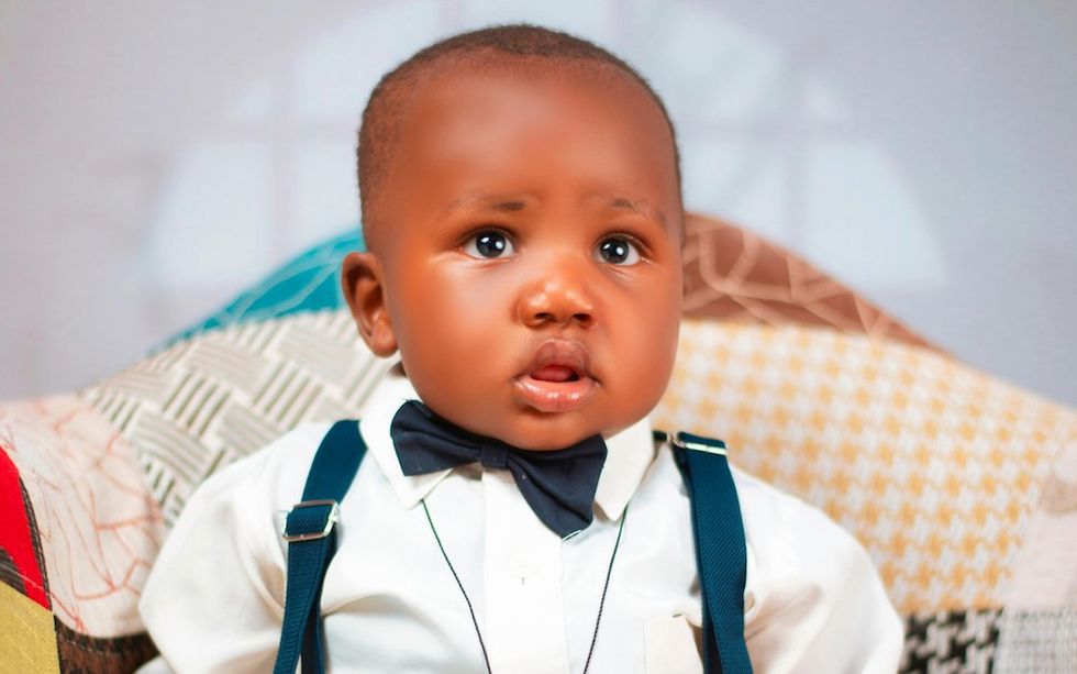 baby in a bowtie and suspenders
