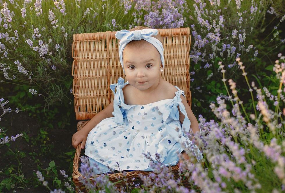 baby sitting in a field of lavender