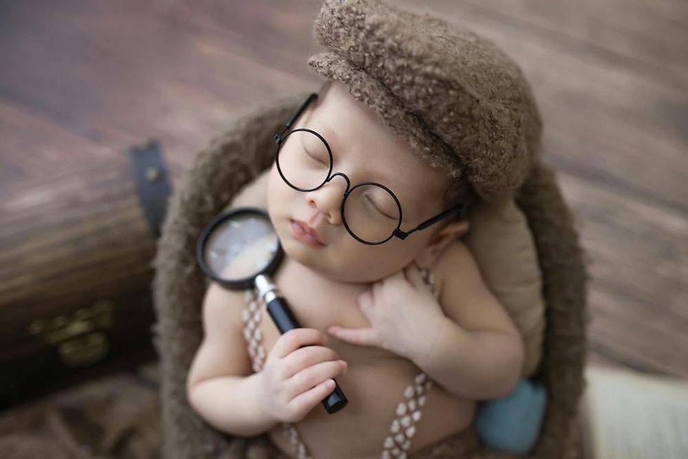 baby wearing glasses and a hat