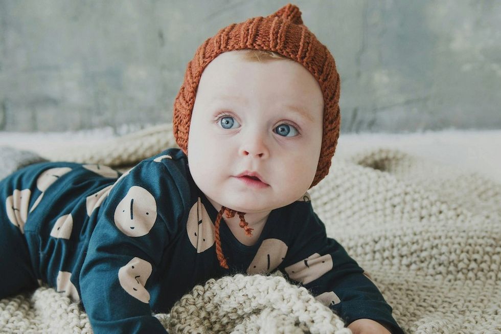 baby with a red bonnet on