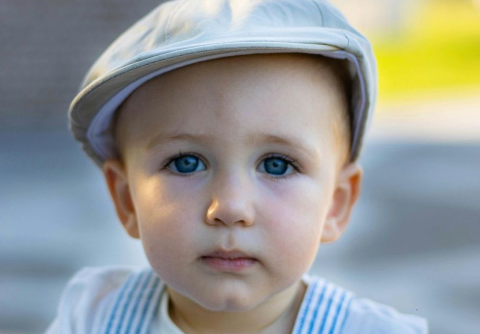 baby with blue eyes and a hat