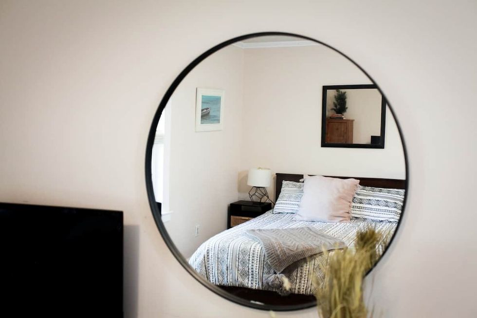 bed reflected in a circular mirror