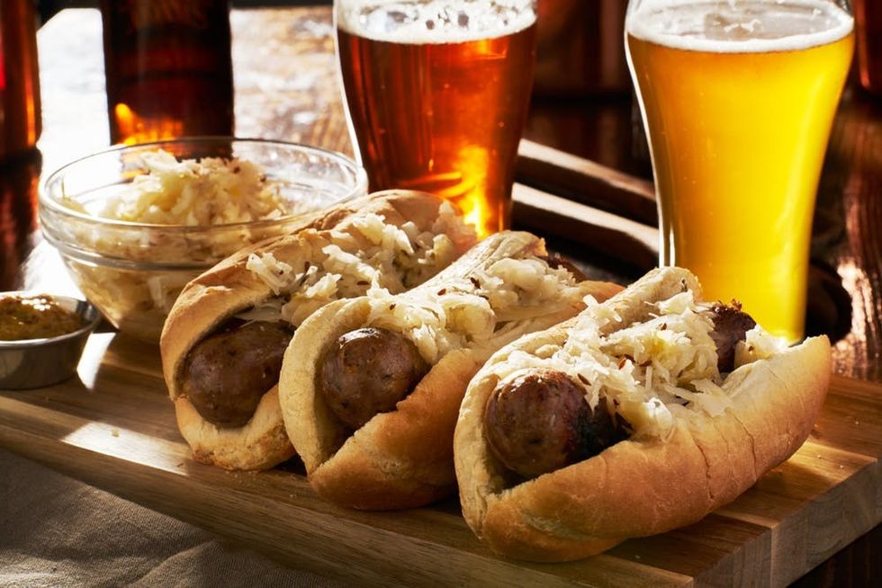 Beer, bratwurst, and saurkraut sit on a table