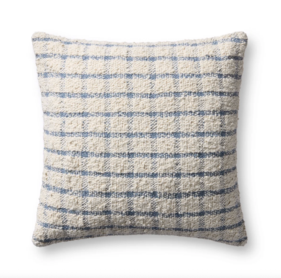 Beige and blue plaid textured pillow on a white background.