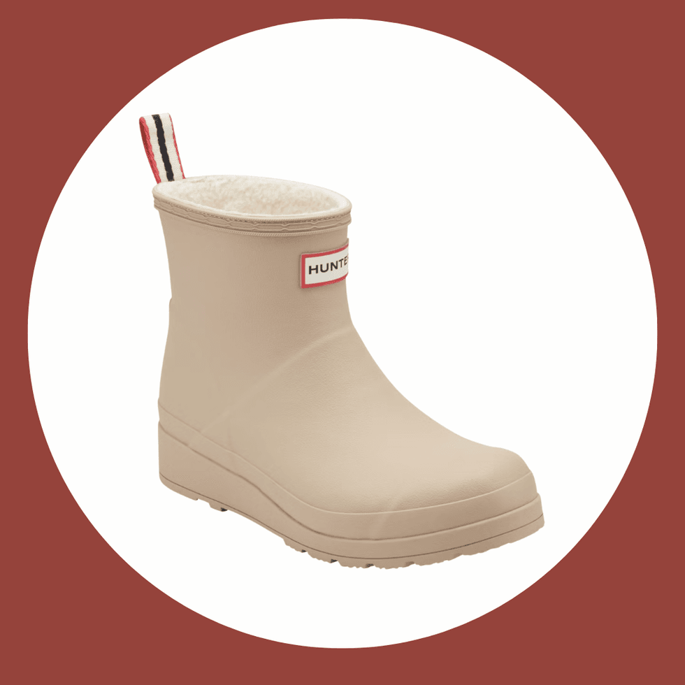 Beige ankle rain boot with a wool lining on a brown circular background.