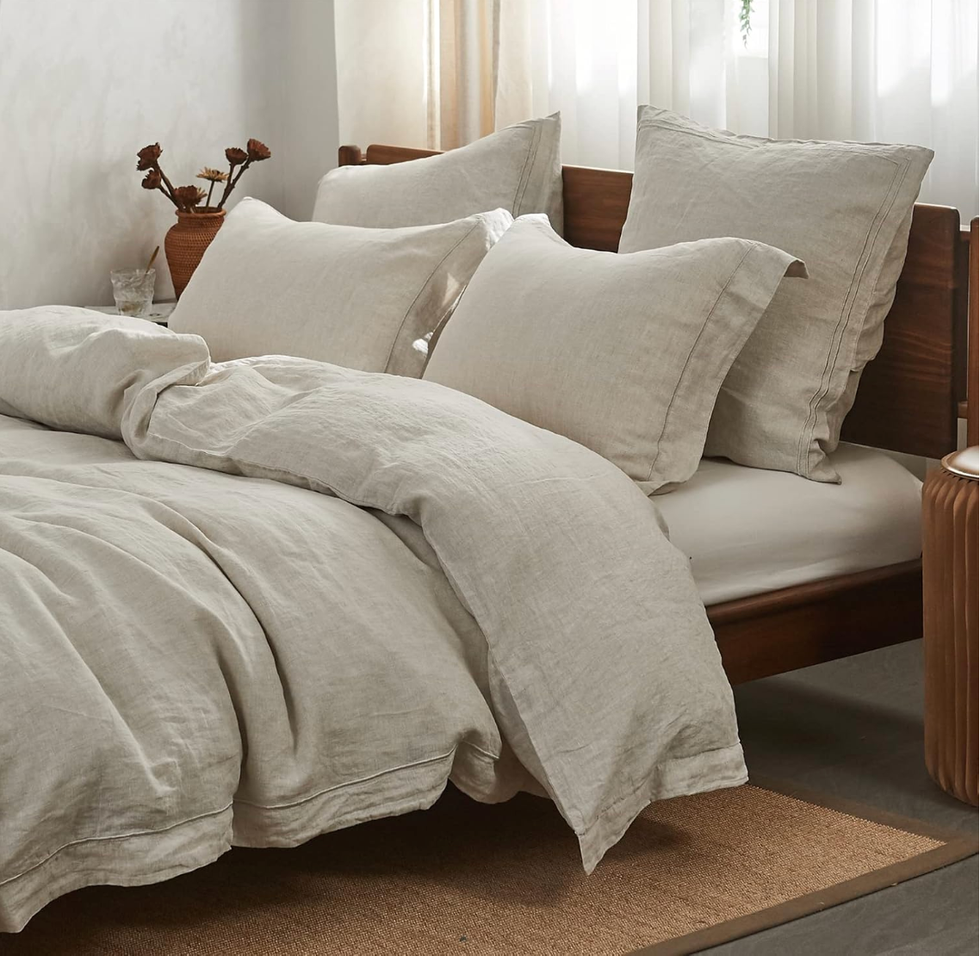 Beige linen bedding on a wooden bed with soft pillows and natural light.