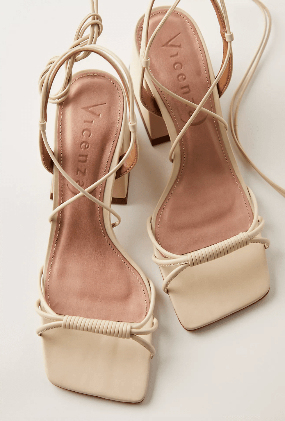 Beige strappy square-toed sandals with block heels and cushioned footbeds.