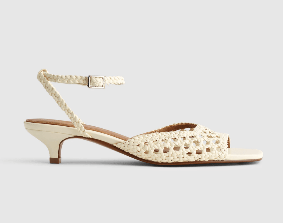 Beige woven sandal with low heel and ankle strap, side view.