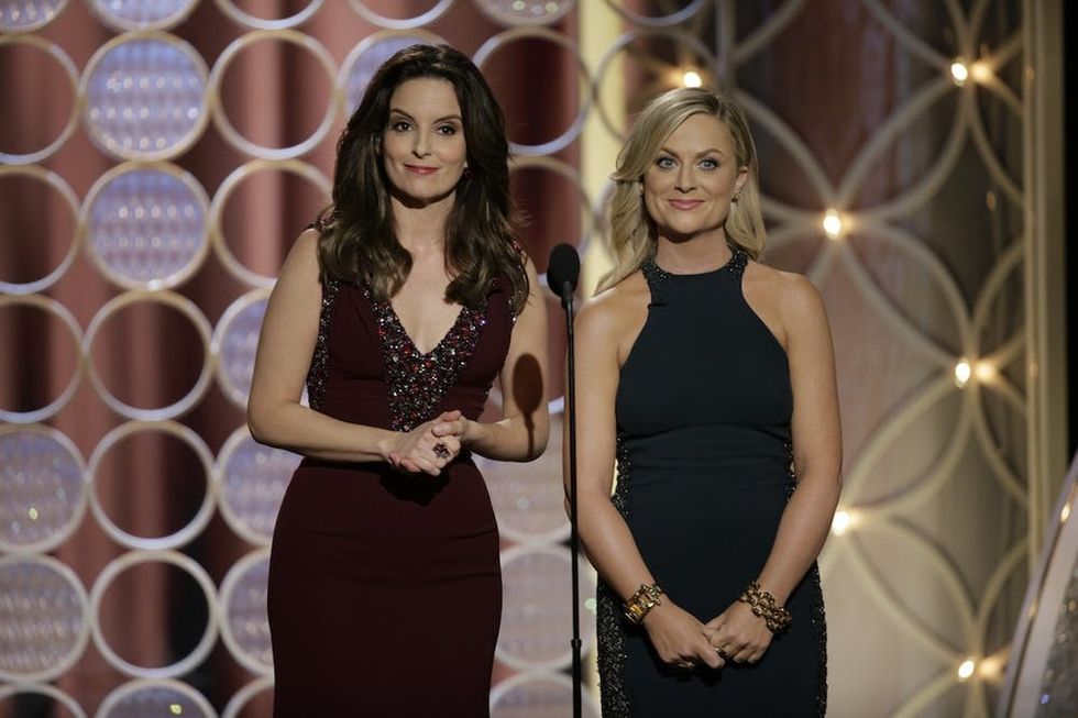 BEVERLY HILLS, CA - JANUARY 12: In this handout photo provided by NBCUniversal, Hosts Tina Fey and Amy Poehler speak onstage during the 71st Annual Golden Globe Award at The Beverly Hilton Hotel on January 12, 2014 in Beverly Hills, California. (Photo by Handout/Getty Images)