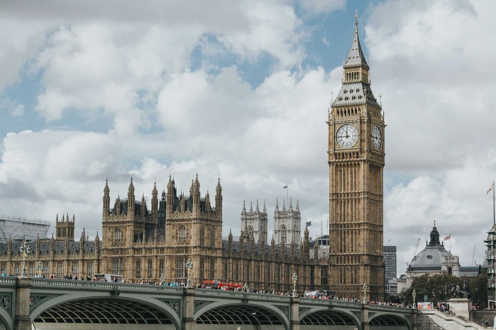 Big Ben and the Houses of Parliament, London, under a cloudy sky.