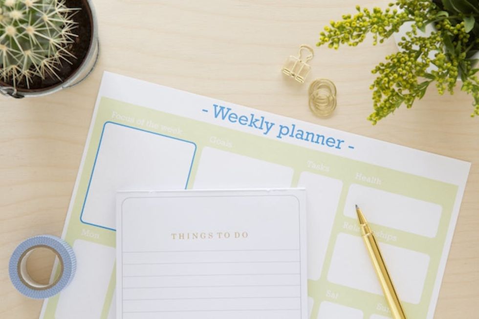 Birdseye of a weekly planner on a table.