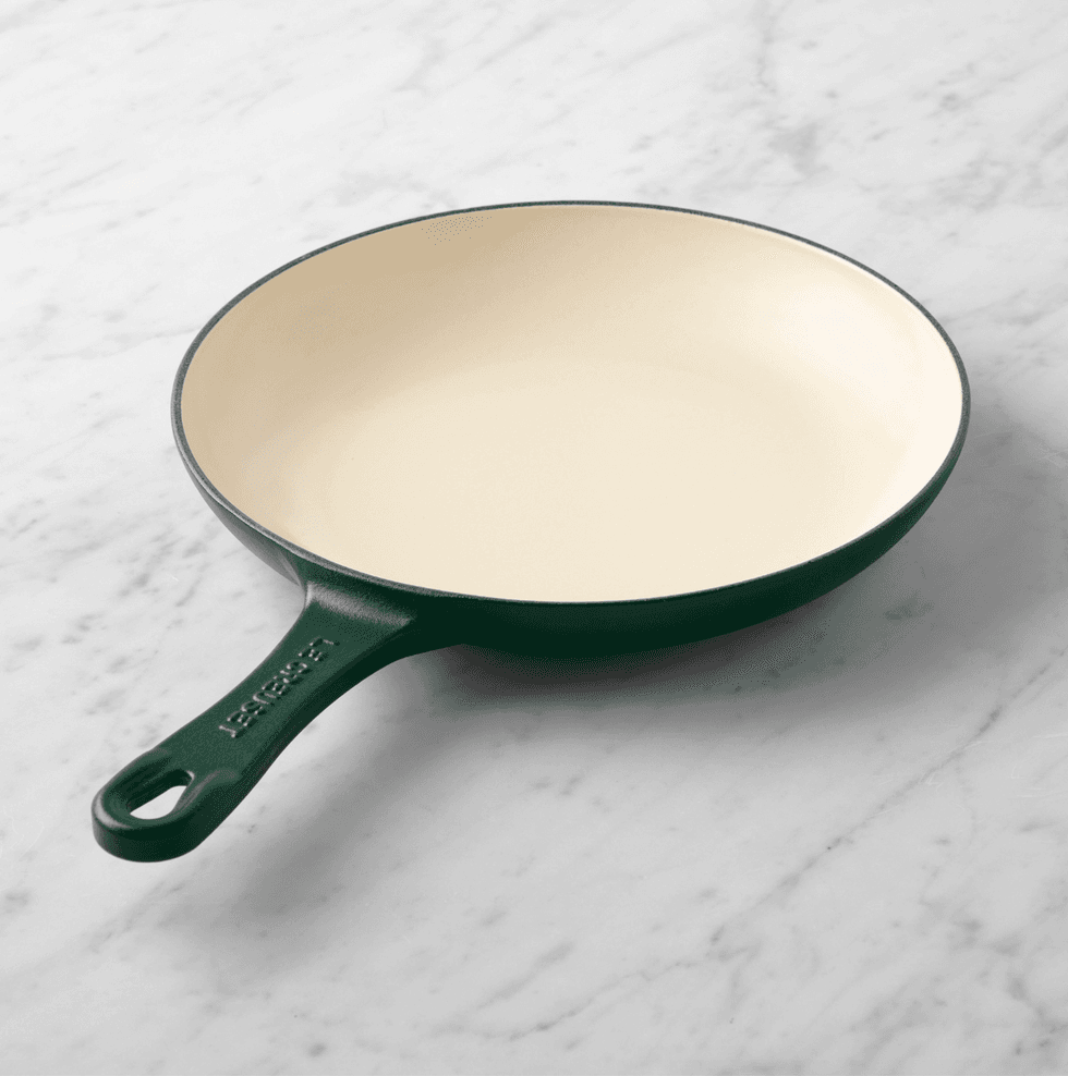 Black and cream skillet on a marble countertop.