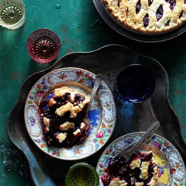blackberry lime pie on rainbow plates and blue napkins