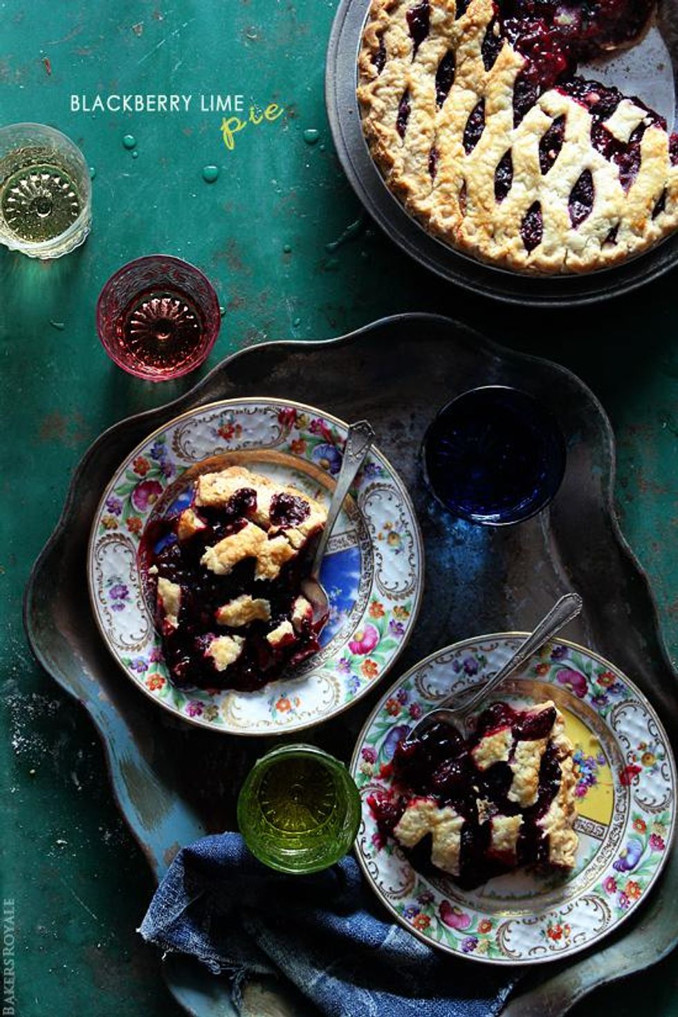 blackberry lime pie on rainbow plates and blue napkins