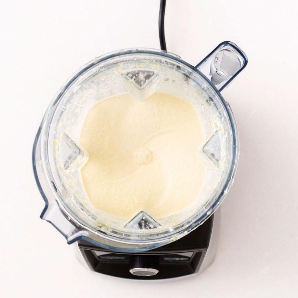 blending ingredients together to make a vegan cheese sauce