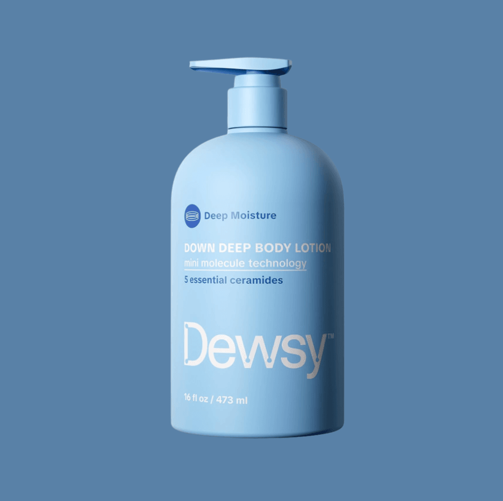 Blue bottle of Dewsy Down Deep Body Lotion on a matching background.