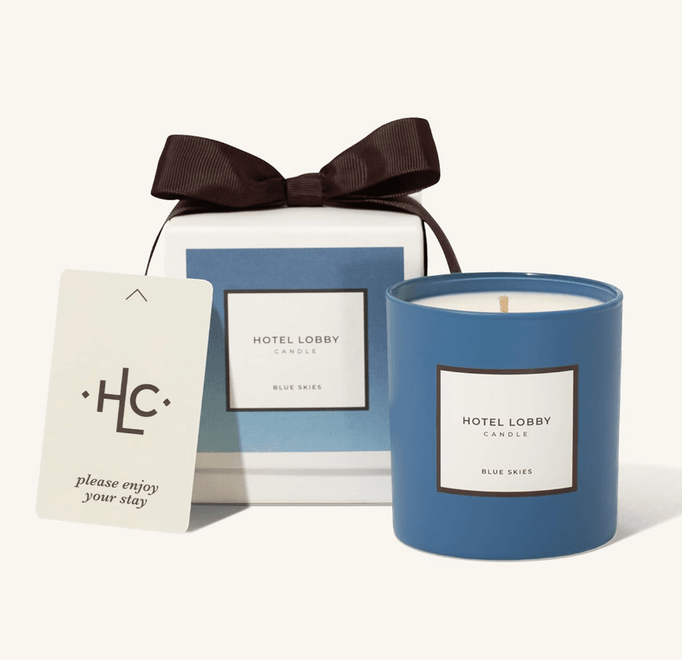 Blue candle and gift box with ribbon, labeled "Hotel Lobby Candle: Blue Skies."