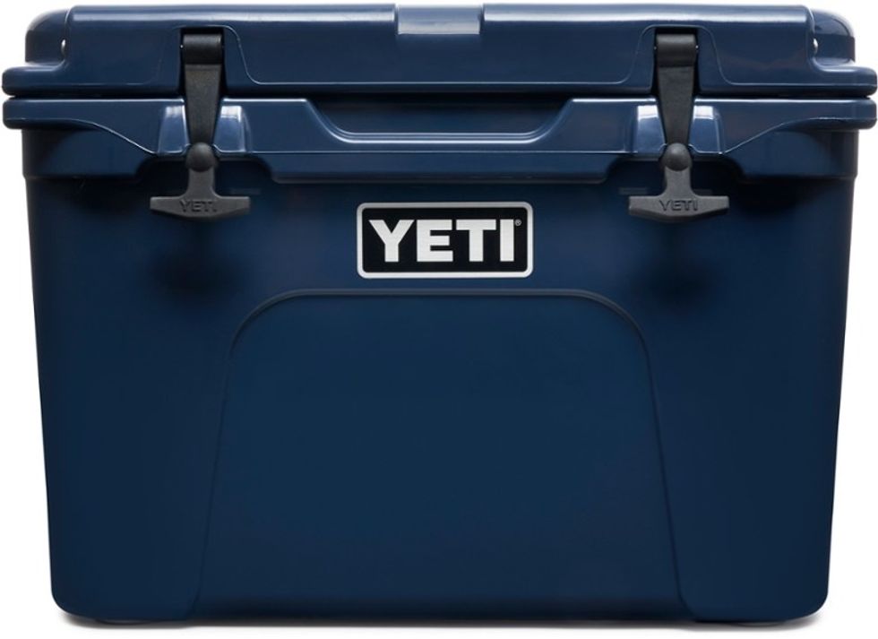 Blue YETI cooler with dual latches and logo on the front.
