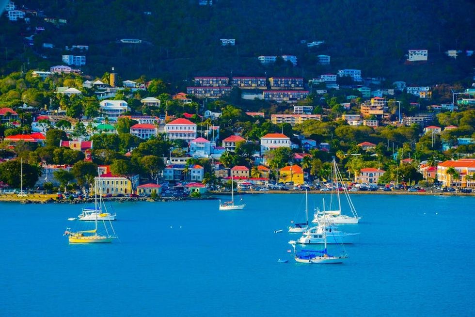Boats float in front of the colorful Charlotte Amalie in the USVI