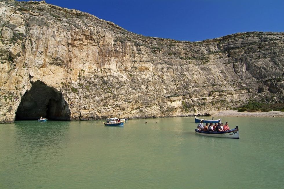 Boats traverse Dwejra Bay on the Inland Sea