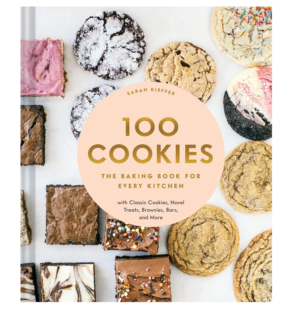 "Book titled '100 Cookies' surrounded by various cookies and brownies."