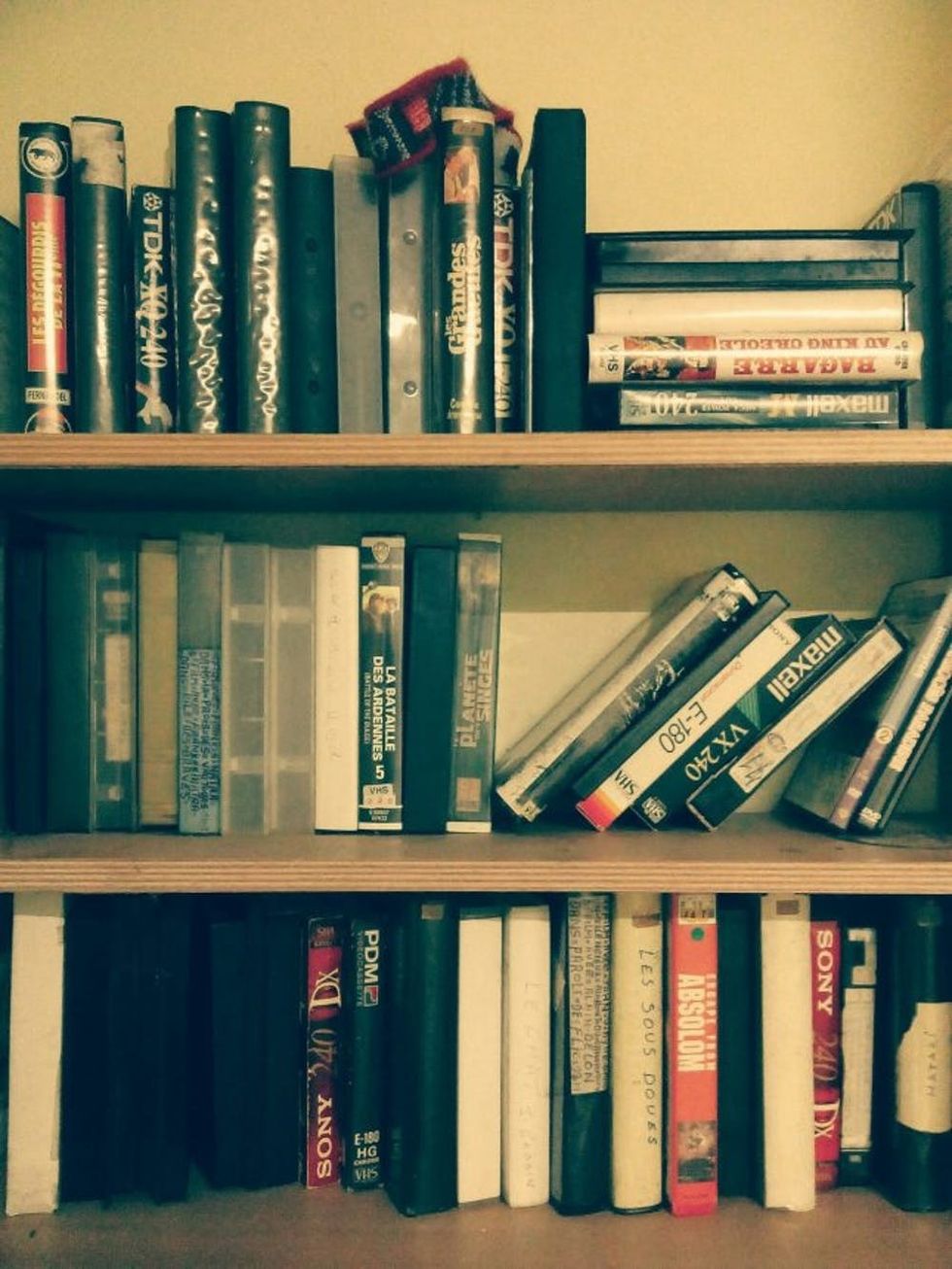 Books And Videocassette On Shelves