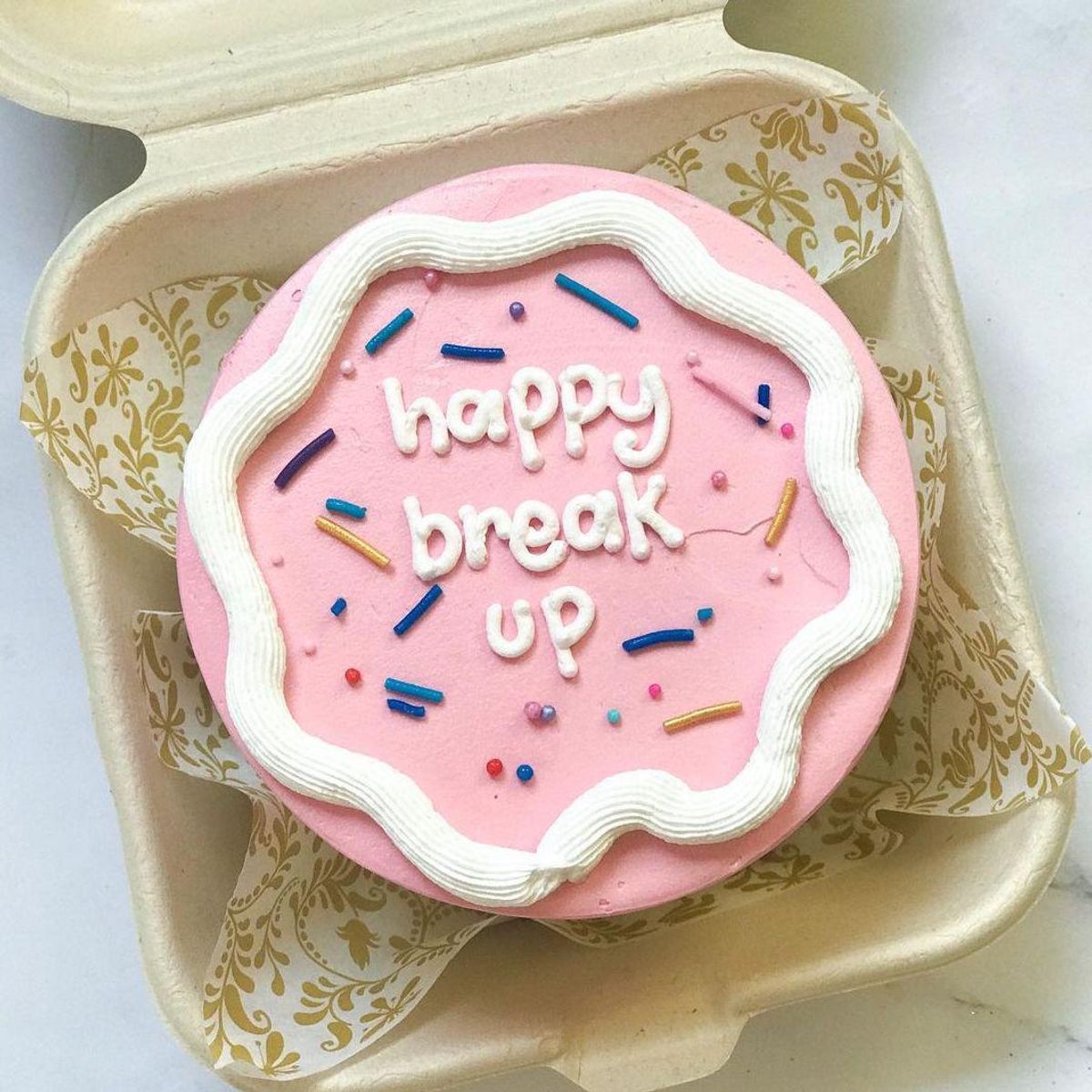 breakup cake ideas pink and white frosting with colorful sprinkles